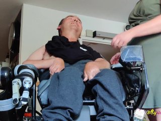 Wheelchair guy gets undressed by his nurse for a handjob